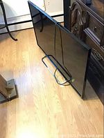 Front view of black Sony flat screen TV on stand