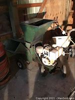 Front view of wood chipper showing hopper, engine and wheels