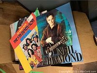 Top view of a collection of vinyl albums showing covers including Neil Diamond and The 5th Dimension.