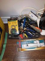 Tray with router box, padlock, pliers, screwdriver, clamp and assorted hardware