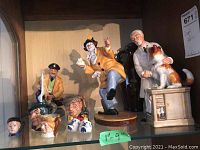 Group shot of seven figurines on shelf