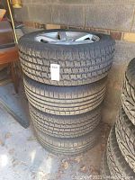 Stacked view of four mounted tires showing block winter tread pattern