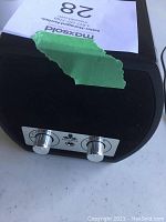 Front view of bottom panel featuring two silver control knobs and Chiyoda logo
