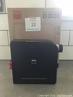 Front view of amplifier with original box behind showing model and packaging