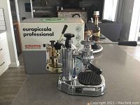 Front view of La Pavoni machine on countertop with box behind