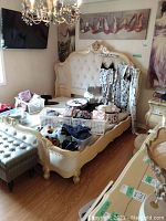 Front view of complete bed frame with headboard and footboard in a staged bedroom setting