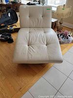 Front view showing tufted leather seat and back