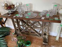 Front view of console table showing wood top and decorative metal base