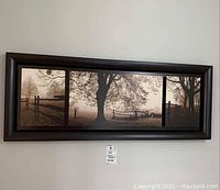 Overall image of dark brown framed triptych featuring three foggy country photo prints.