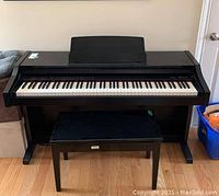Full front view of piano with bench