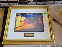 Frontal view of the matted and framed Rock-A-Doodle production cel showing character and neon signage background.