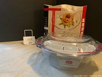Two photos of the Termsil 4.6L glass grill and drop system cookware set, showing the grill pan and matching lid along with the original box.