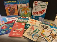 Photo of 15 children's books laid out including Dr. Seuss, Disney, Spot and others.