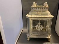 Front and side view of vintage garden lantern showing intricate metalwork and glass panels