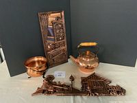 Four vintage copper items from Coppercraft Guild: embossed wall panel, kettle, pedestal bowl, and key holder.