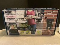 Boxed KiVOS multifunctional wireless video intercom showing product front panel and features.