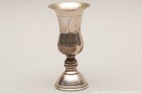 Side view of sterling silver etched goblet showing the flared rim, etched patterns, and stepped base.