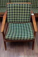 Front view of wooden frame and plaid cushions