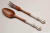 Pair of 11-inch wooden salad tongs with ornate sterling silver handles, showing full length and design.