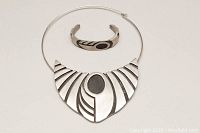 Photo of vintage pewter choker necklace and cuff bangle showing geometric black inlay designs and overall condition