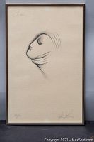 Framed lithograph showing stylized profile of a face with hands, signed by Helen Lucas and numbered 35/50
