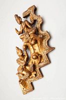 Front angled view of the hand carved wooden wall hanging showing two seated Asian spiritual figures with detailed gold and brown paint.