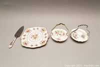 Cake cutter, candy bowls and cake plate arranged together showing full set