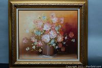 Full view of framed floral oil on canvas painting showing detailed flowers and vase with warm color background.