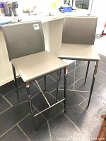 Front view of both stools side by side in kitchen setting