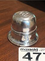 Silver plated round ring box closed, showing embossed Birks logo on top.