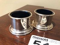 Pair of polished sterling silver salt cellars with cobalt blue glass liners inside.