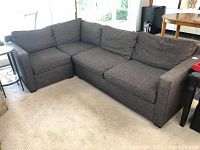 Front view of gray L-shaped sectional sofa in living room