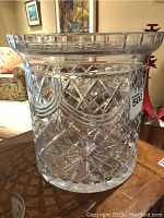 Front and side views of the large crystal ice bucket showing detailed cut glass patterns and wide rim.