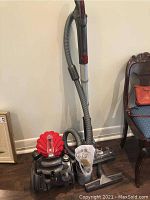 Full view of vacuum with hose, wand and powerhead on floor