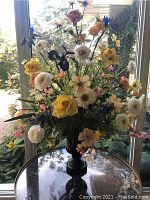 Front view of the full artificial floral arrangement in the decorative vase.