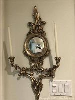 Front view of the Florentine convex mirror with candle sconces mounted on wall, showing overall size and details.