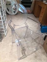 Clear acrylic Ghost Chair shown from the front angle, highlighting its transparent material and modern design.