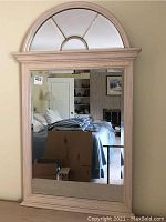 Full view of the wall mirror showing wooden frame, rectangular mirror bottom, and arched mirror top with decorative muntins.