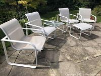 Overview of entire patio set arranged on stone patio