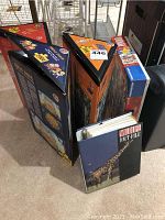 Photo showing multiple triangular 2000-piece Heye puzzles and one rectangular 1000-piece Ravensburger puzzle along with Wildlife Fact File binder.