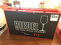 Box of Riedel wine glasses with brand name visible and quantity 2+2.