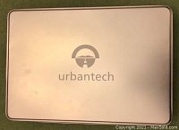 Closed metal tin box with Urbantech logo on the lid