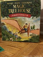 Front cover of the slipcase box set for Magic Tree House Books 1-28 showing illustrated children riding a pterodactyl.