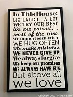 Black framed Family Rules sign with white background and text listing household values.