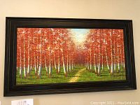 Full view of the oil painting showing birch trees with orange leaves and a dirt path, framed in black wood.