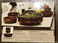 Photo of the full set on white table with salad in bowl, showing size and finish of hardwood bowls.