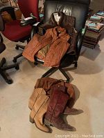 Overall lot showing vests on a chair and boots on the floor