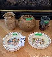 All 5 items on floor in front of fireplace: two Bunnykins dishes and three pottery vases; sizes range 7-8.5 inches; chips visible