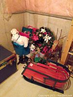 Overview of Christmas decorations including stuffed polar bears, wreaths, wooden log reindeer, and red wooden sleigh