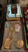 Vintage jewellery box, trinket box, and metal vanity set displayed on a mirrored tray.